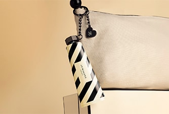 Launch image of advent calendar dartboard box shown open with examples of 5 product contents on checkerboard background.